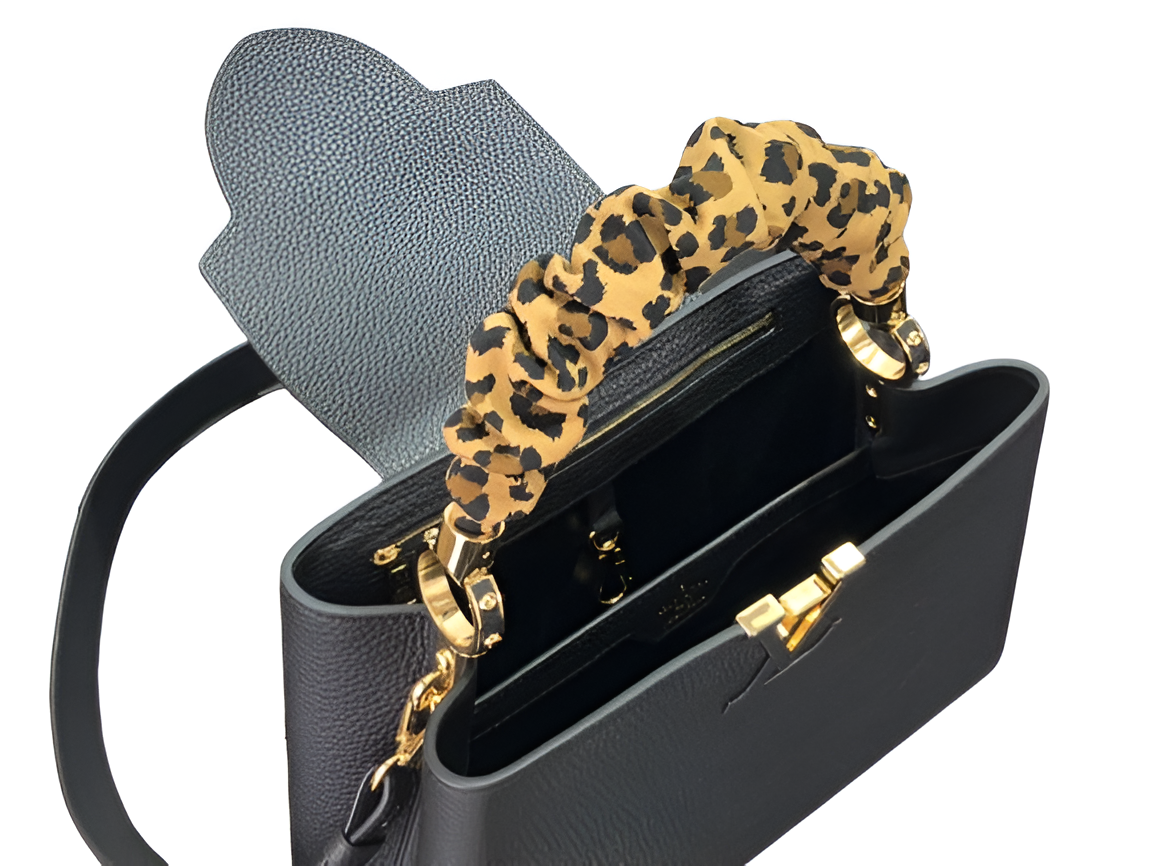 Louis Vuitton black handbag with a stylish leopard print handle
